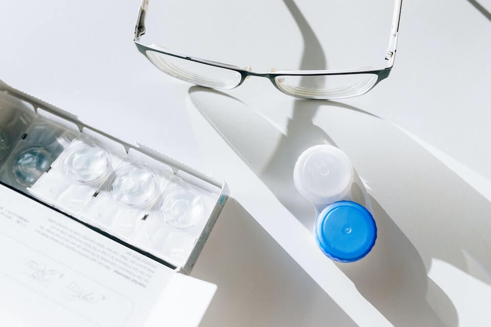 Contacts case next to eyeglasses