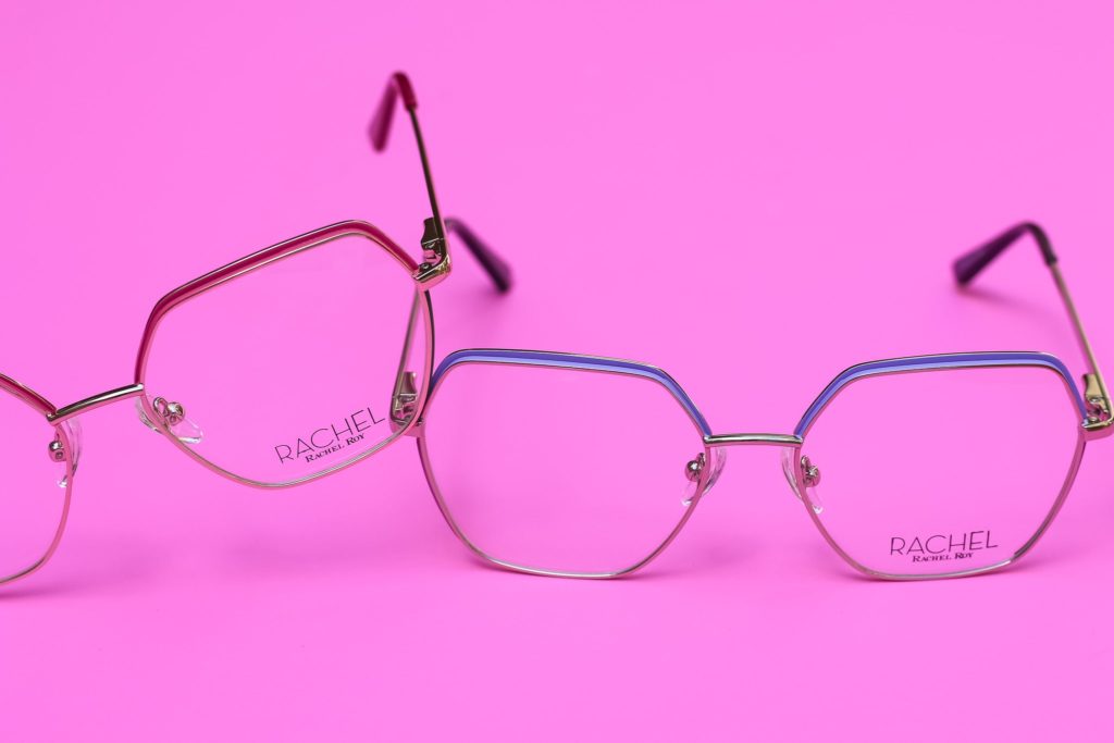 Rachel Roy eyeglasses on a pink background