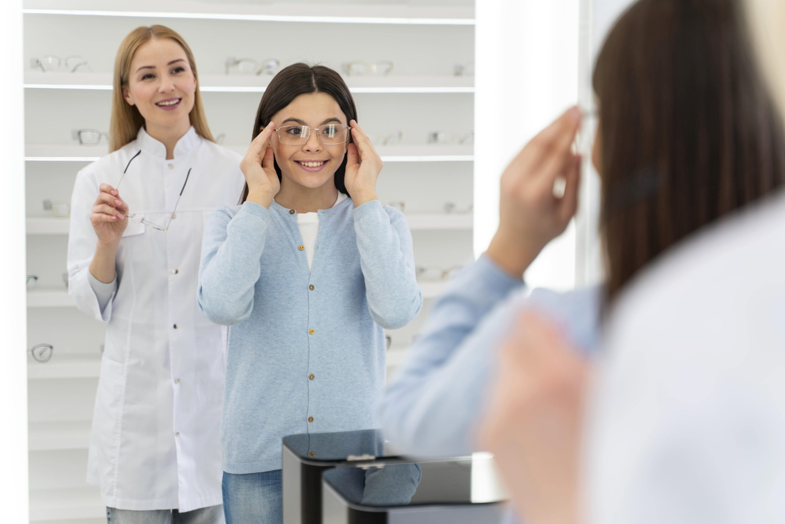 Little girl trying on eyeglasses from A&A Optical